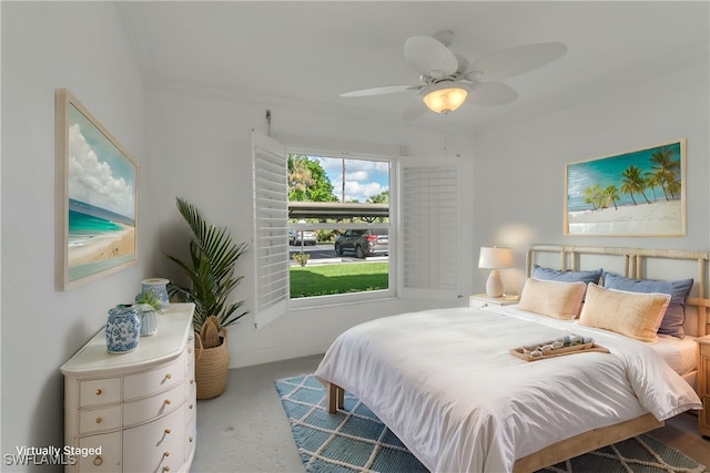 carpeted bedroom with ceiling fan and crown molding