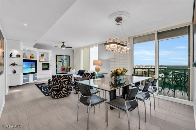 dining room with ceiling fan with notable chandelier