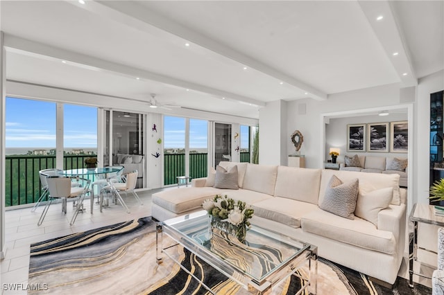 living room featuring beamed ceiling and ceiling fan