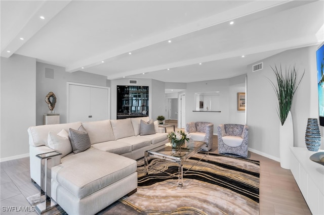 living room with beamed ceiling and light hardwood / wood-style floors