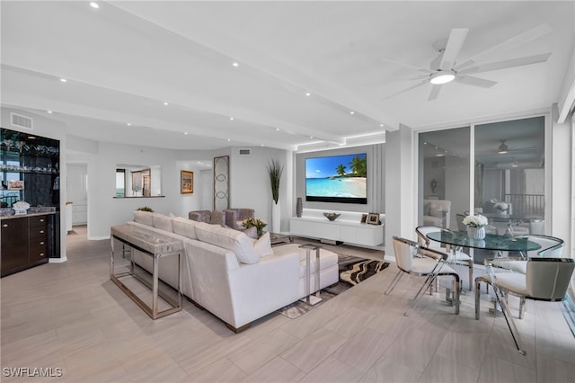 living room with beam ceiling and ceiling fan