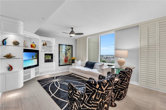 living room with ceiling fan and hardwood / wood-style floors