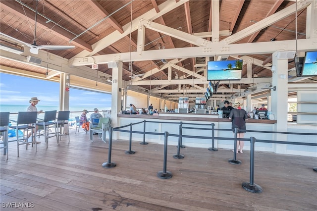 game room with beam ceiling, wooden ceiling, a water view, and wood-type flooring