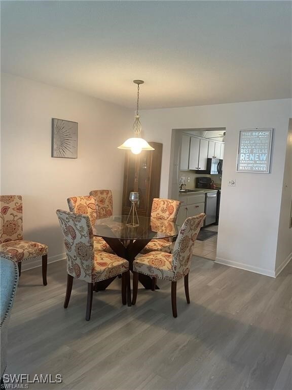 dining area with hardwood / wood-style flooring and sink