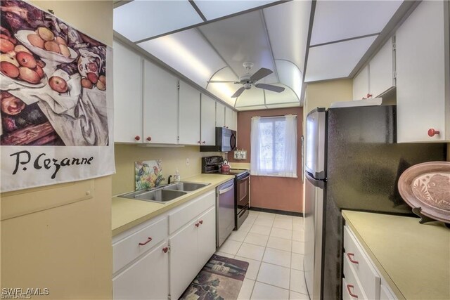 kitchen featuring stainless steel appliances, sink, ceiling fan, light tile patterned floors, and white cabinets