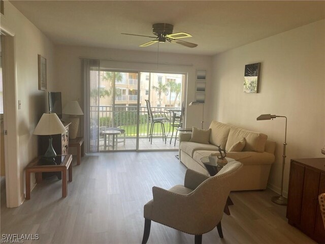 living room featuring ceiling fan and light hardwood / wood-style flooring