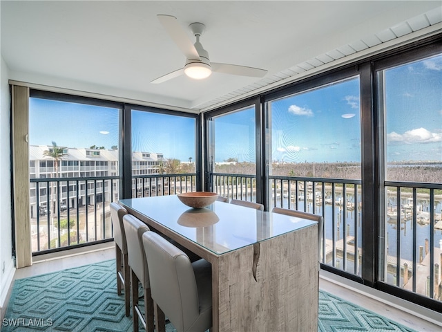 sunroom / solarium featuring a wealth of natural light and a water view