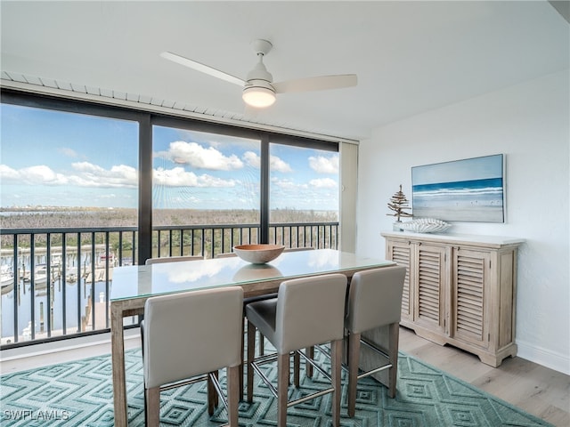 dining room with light hardwood / wood-style floors and ceiling fan