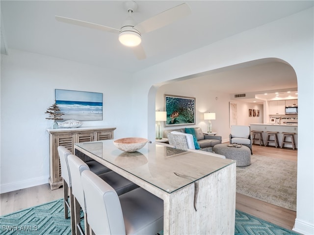 dining room featuring light wood-type flooring and ceiling fan