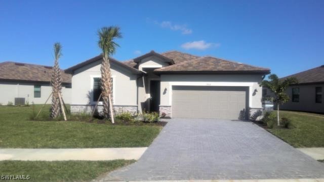 view of front of house with a front lawn and a garage