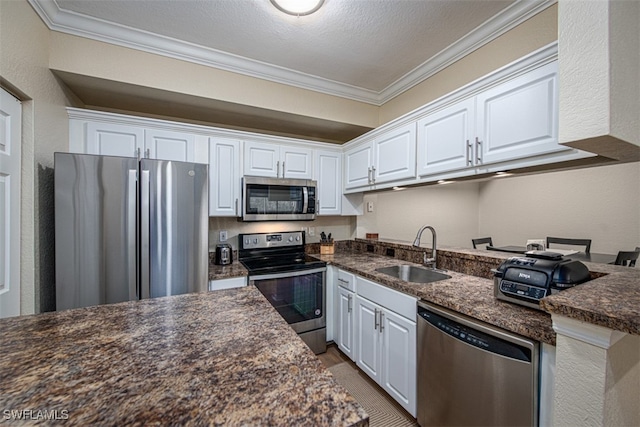 kitchen featuring white cabinets, crown molding, sink, and appliances with stainless steel finishes