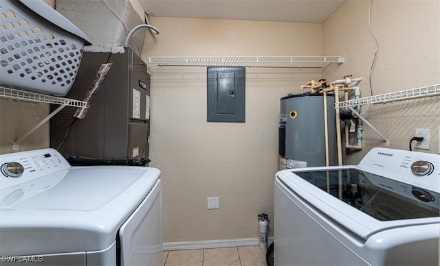 laundry room with electric panel, water heater, light tile patterned floors, and washing machine and dryer