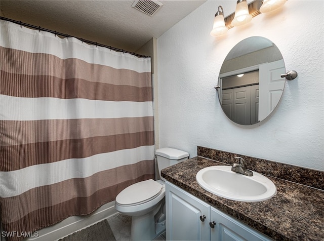 bathroom with vanity, a textured ceiling, toilet, and curtained shower