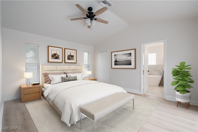 bedroom featuring ceiling fan, light hardwood / wood-style flooring, connected bathroom, a closet, and lofted ceiling