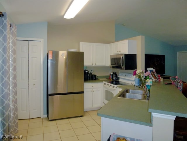 kitchen with lofted ceiling, sink, white cabinetry, and stainless steel appliances