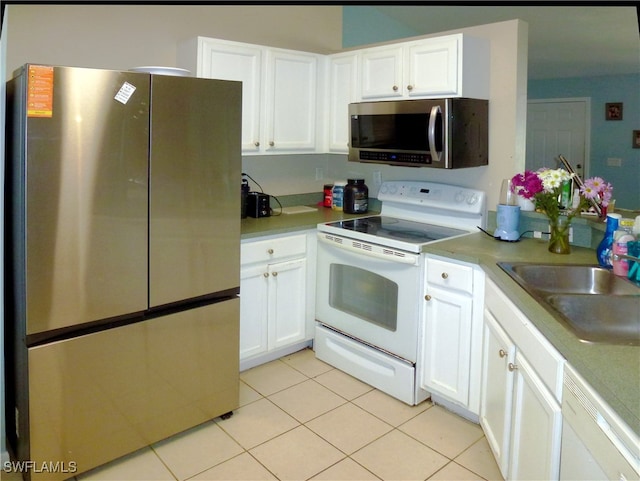 kitchen featuring sink, white cabinetry, stainless steel appliances, and light tile patterned floors