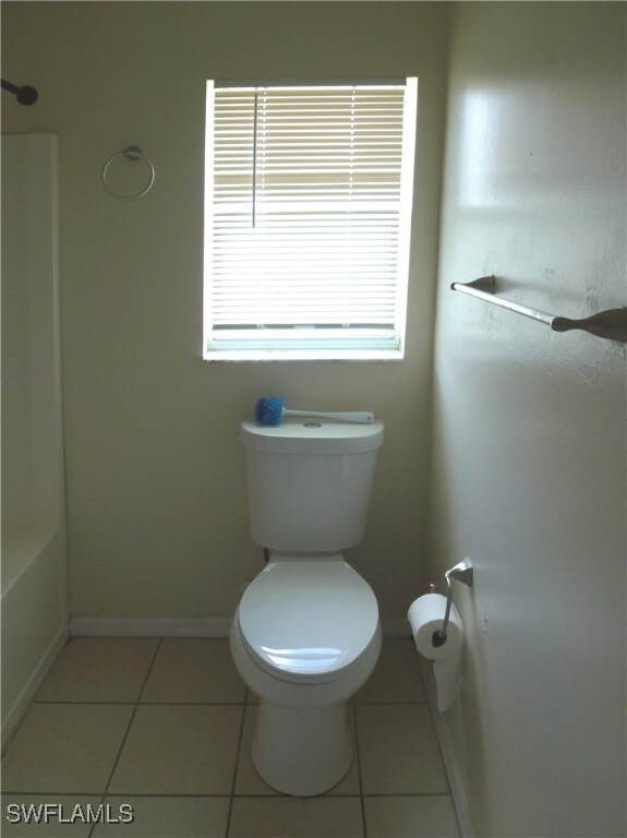 bathroom with toilet and tile patterned flooring