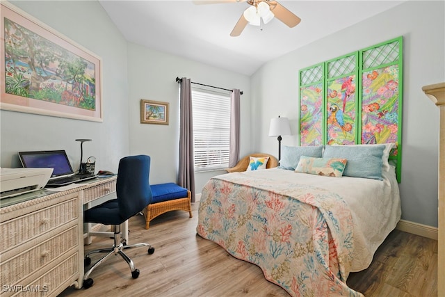 bedroom with lofted ceiling, hardwood / wood-style floors, and ceiling fan