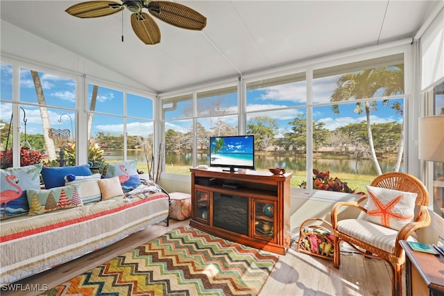 sunroom featuring lofted ceiling and ceiling fan