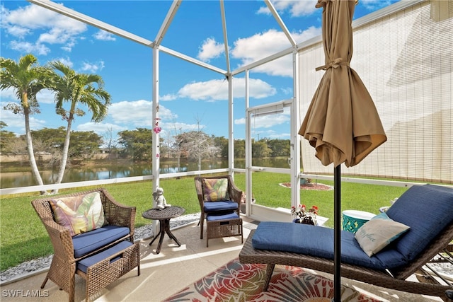 sunroom featuring a water view