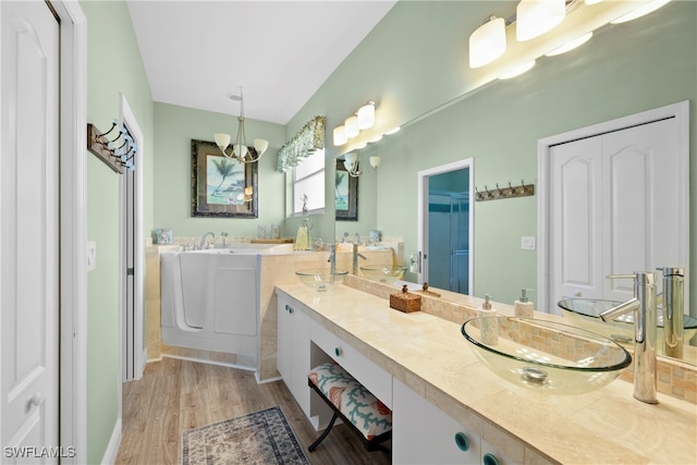 bathroom featuring a notable chandelier, vanity, and wood-type flooring