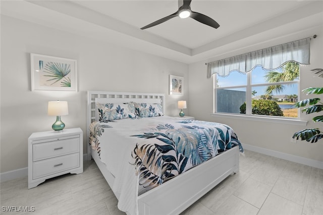 tiled bedroom featuring ceiling fan