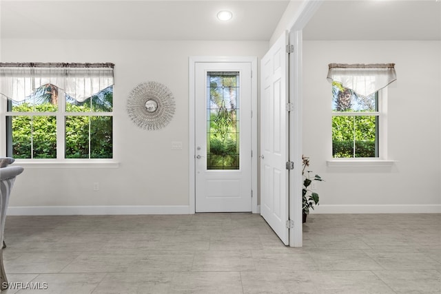 foyer featuring a healthy amount of sunlight and light tile patterned floors