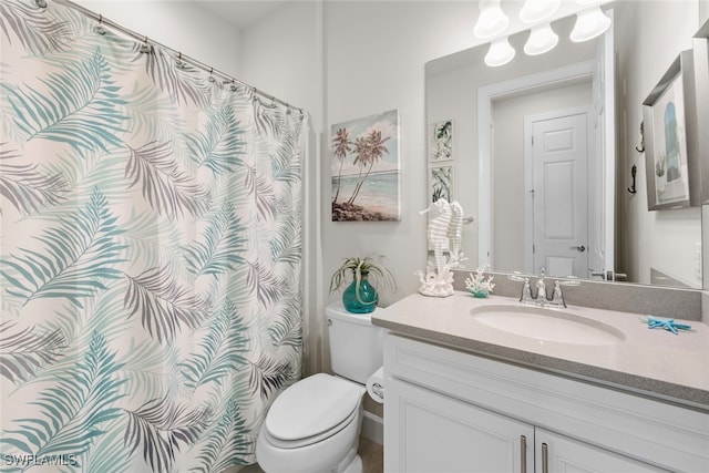 bathroom featuring toilet and vanity