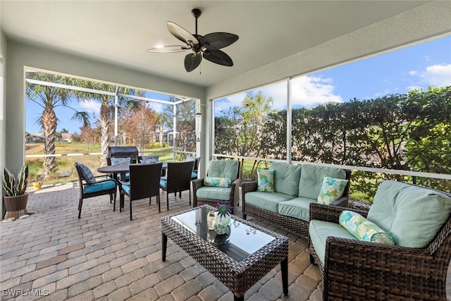 sunroom / solarium featuring ceiling fan