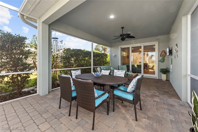 sunroom featuring ceiling fan