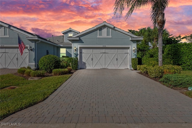 view of front of property featuring a lawn and a garage