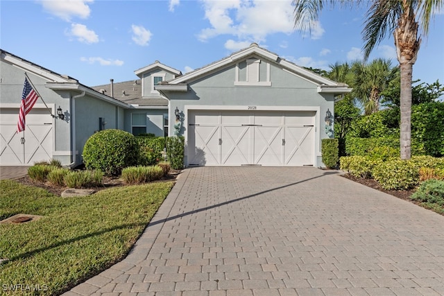 view of front of home featuring a garage and a front yard