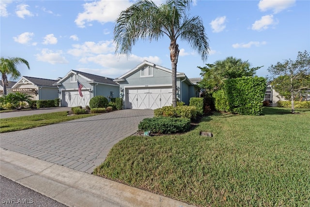 view of front of home with a front yard and a garage