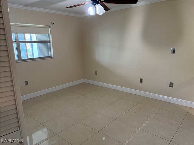 spare room featuring ceiling fan, light tile patterned floors, and ornamental molding