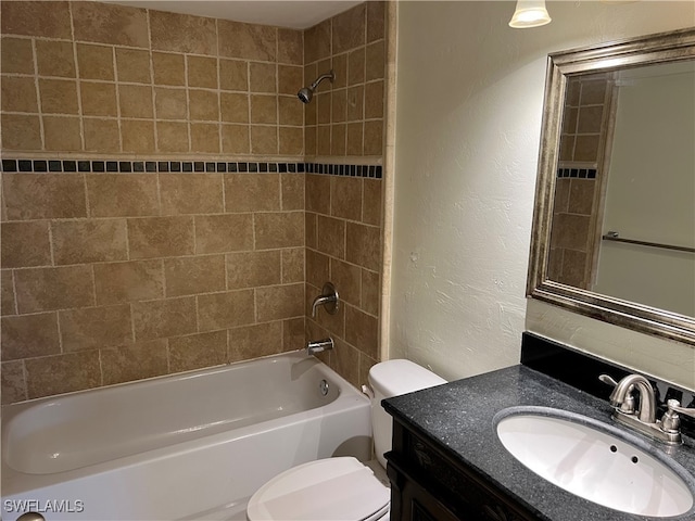 full bathroom with vanity, toilet, and tiled shower / bath combo