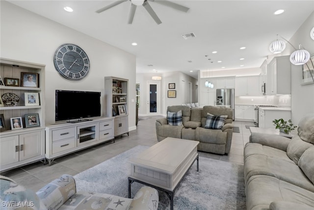 tiled living room with ceiling fan