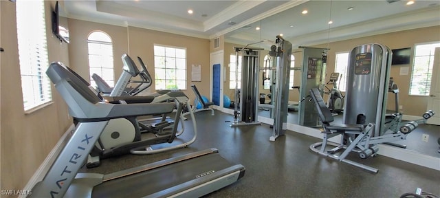 workout area featuring ornamental molding and a tray ceiling