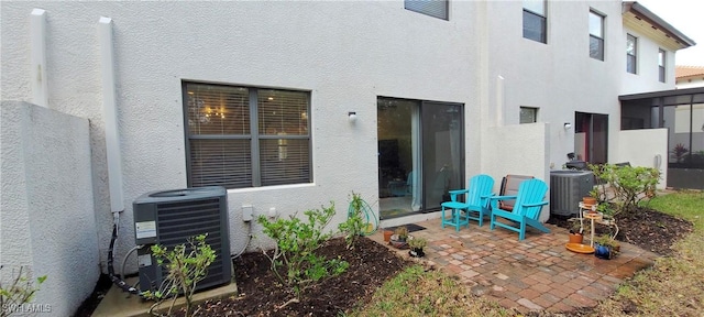 rear view of property with a patio and central air condition unit