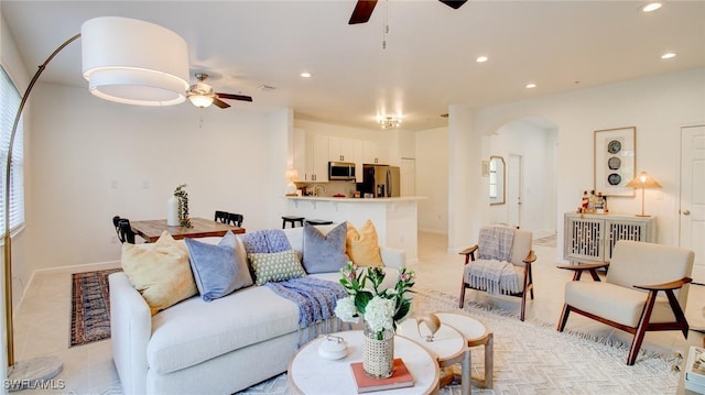 tiled living room with ceiling fan