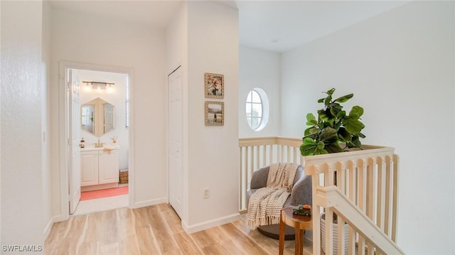 hallway with radiator heating unit and light wood-type flooring