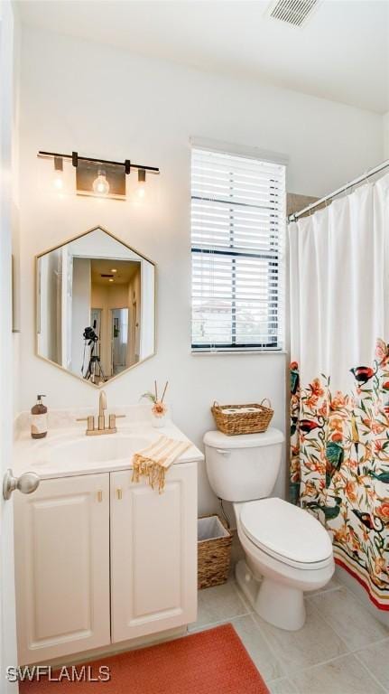 bathroom with tile patterned floors, toilet, and vanity