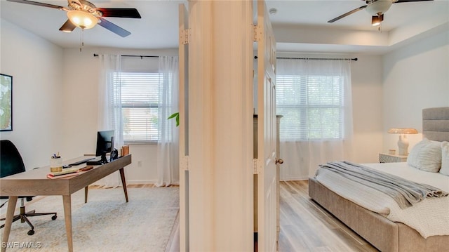 bedroom featuring ceiling fan and light hardwood / wood-style flooring