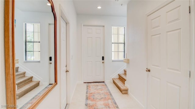 entryway with light tile patterned floors and plenty of natural light