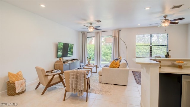 living area with plenty of natural light, light tile patterned floors, and ceiling fan