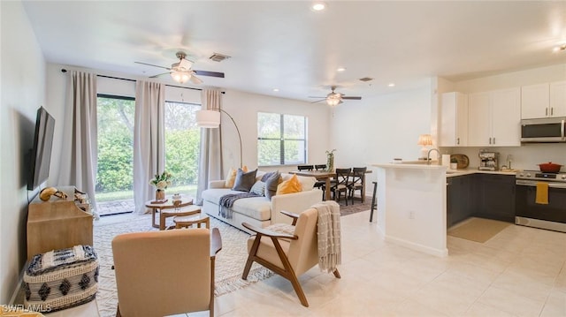 living room with sink and ceiling fan