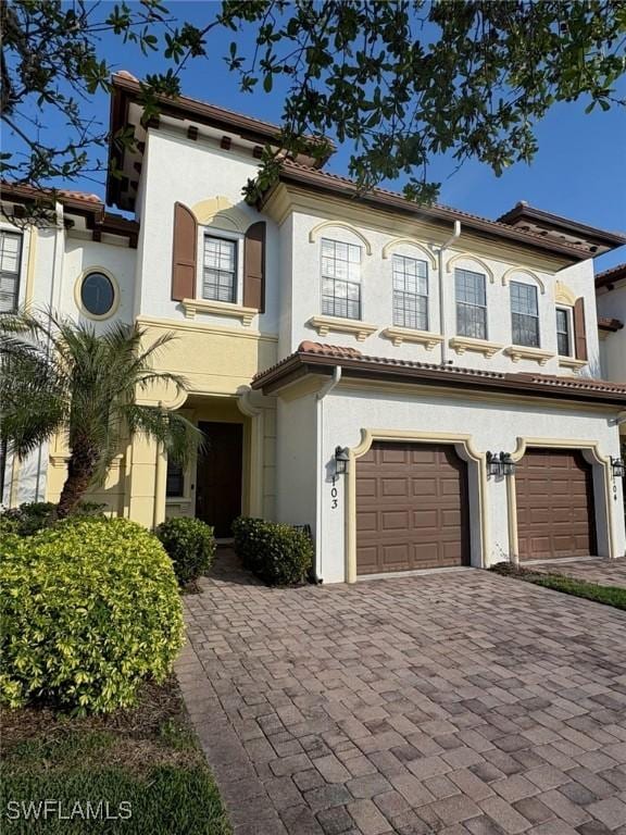 mediterranean / spanish house with a garage