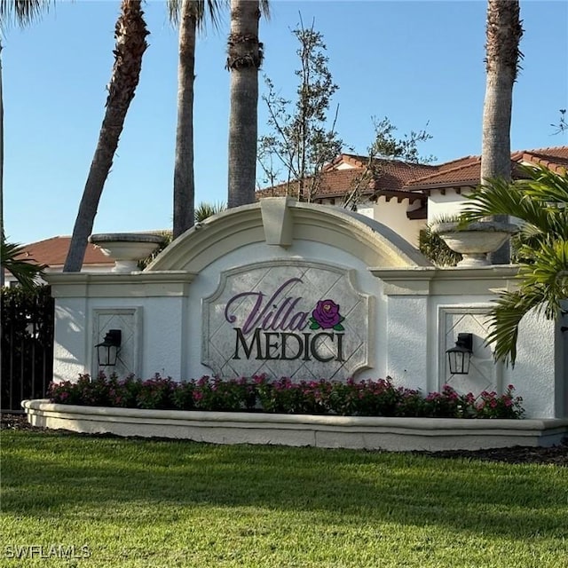 community / neighborhood sign featuring a lawn