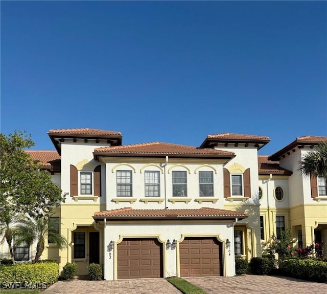 mediterranean / spanish-style home featuring a garage