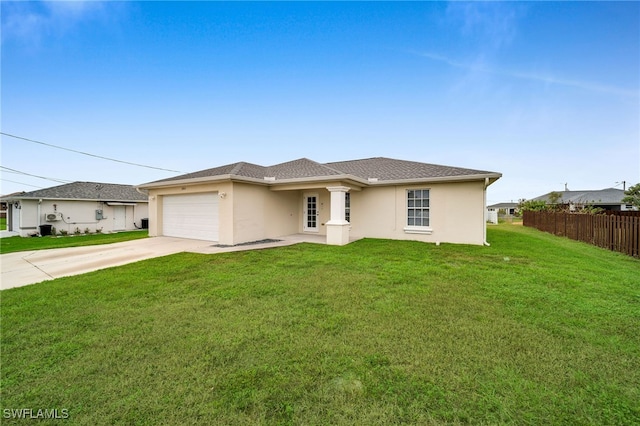 view of front of house with a garage and a front lawn