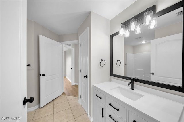 bathroom featuring a shower, tile patterned flooring, and vanity